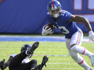 New York Giants wide receiver Odell Beckham (13) runs away from a defender during the second half of Sunday's game against the Baltimore Ravens. (Bill Kostroun / AP)